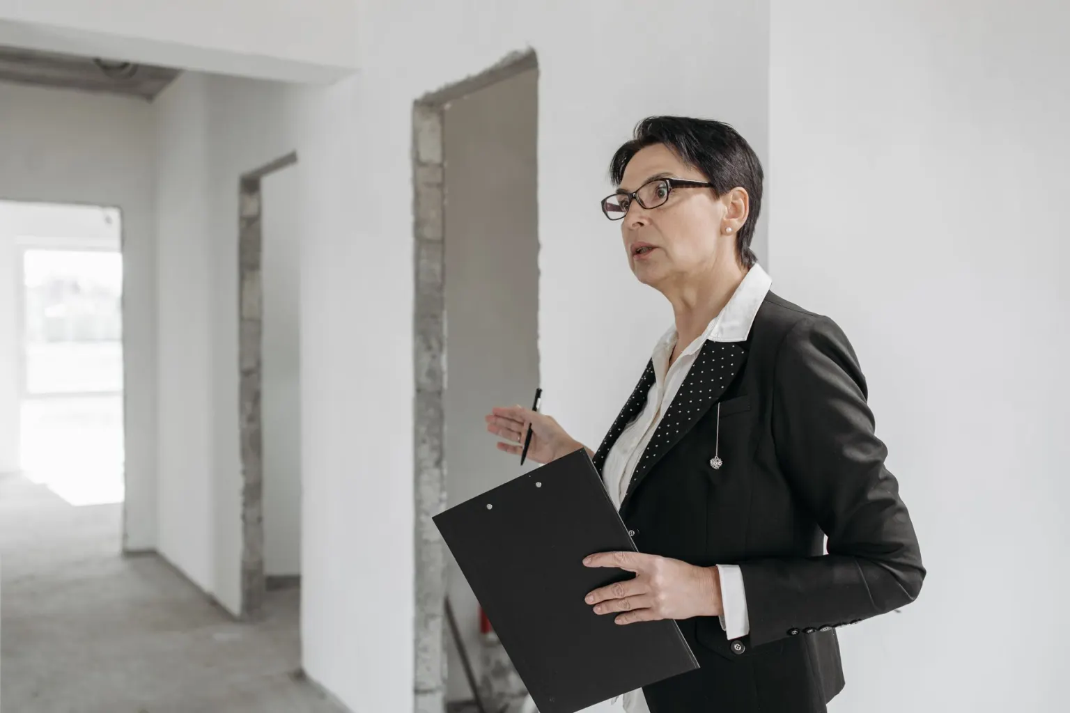 Property inspection being carried out inside an unfinished building